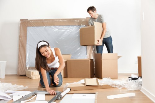 Professional removals team handling furniture in a Tufnellpark flat move